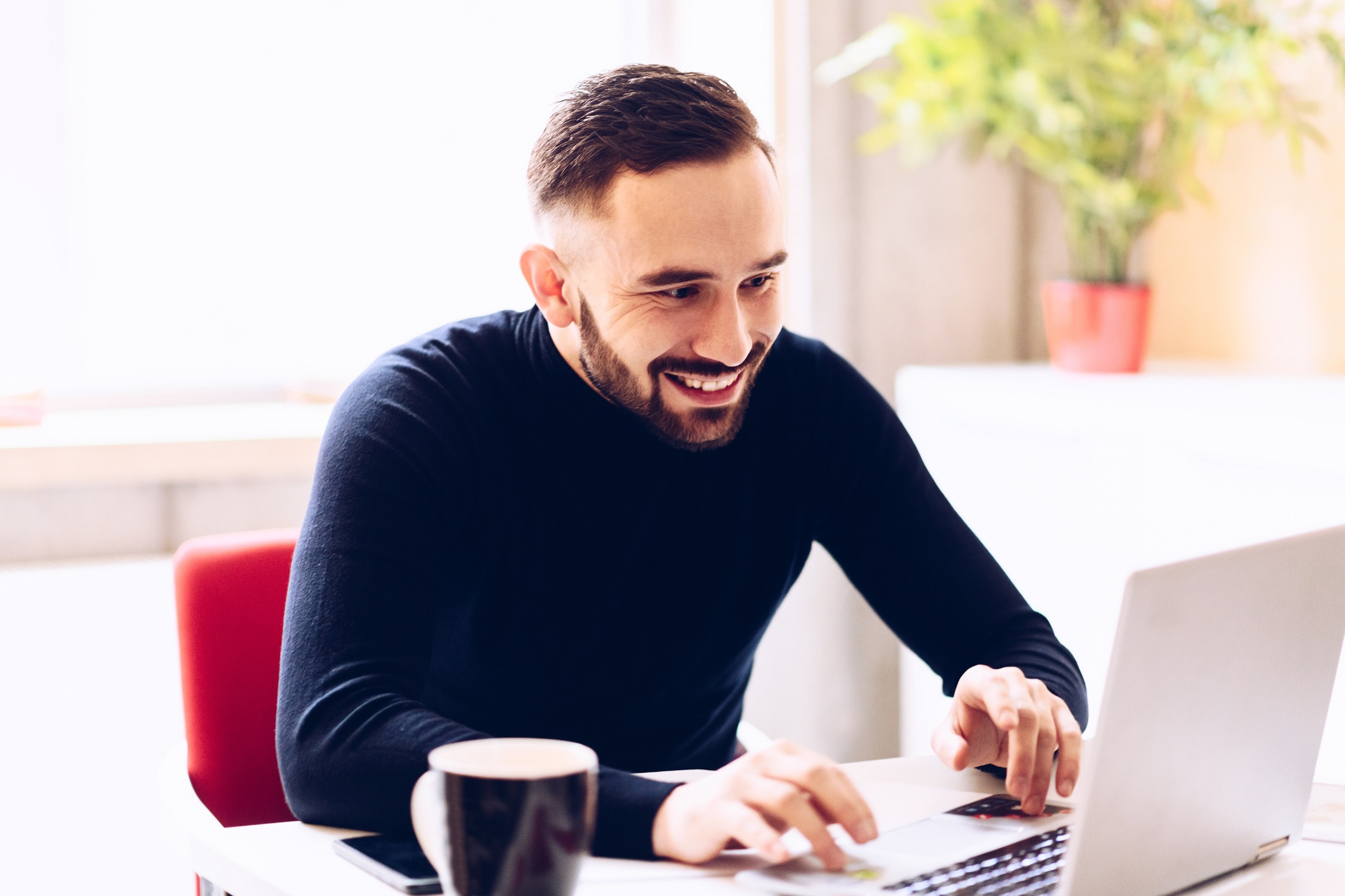 man smiling at computer