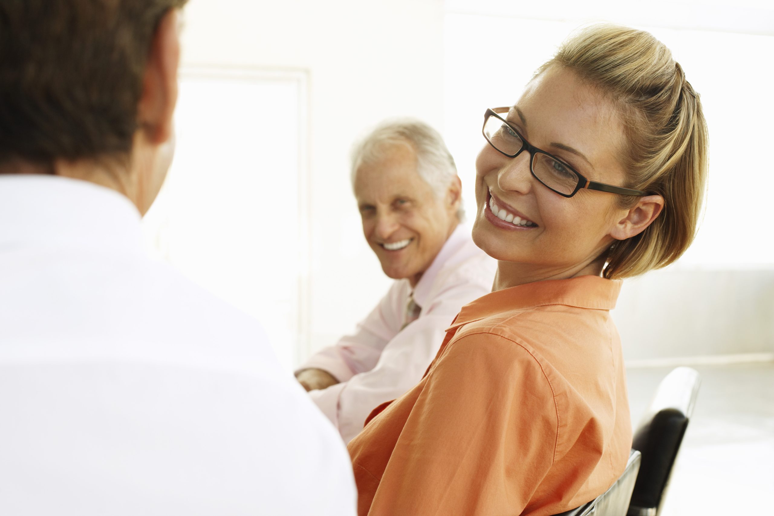 woman smiling in orange shirt